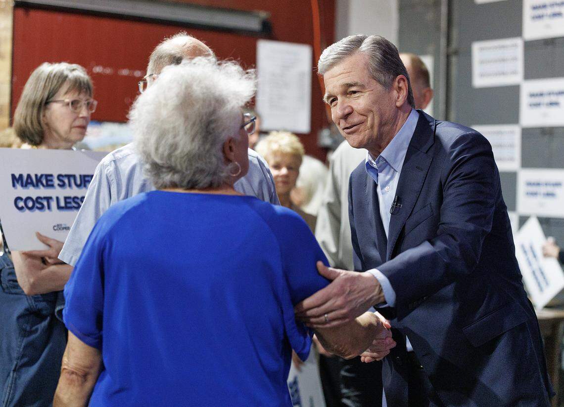 Former North Carolina governor and U.S. Senate candidate Roy Cooper greets a guest during an event at Clouds Brewing Taproom on Wednesday, March 4, 2026, in Raleigh, N.C.