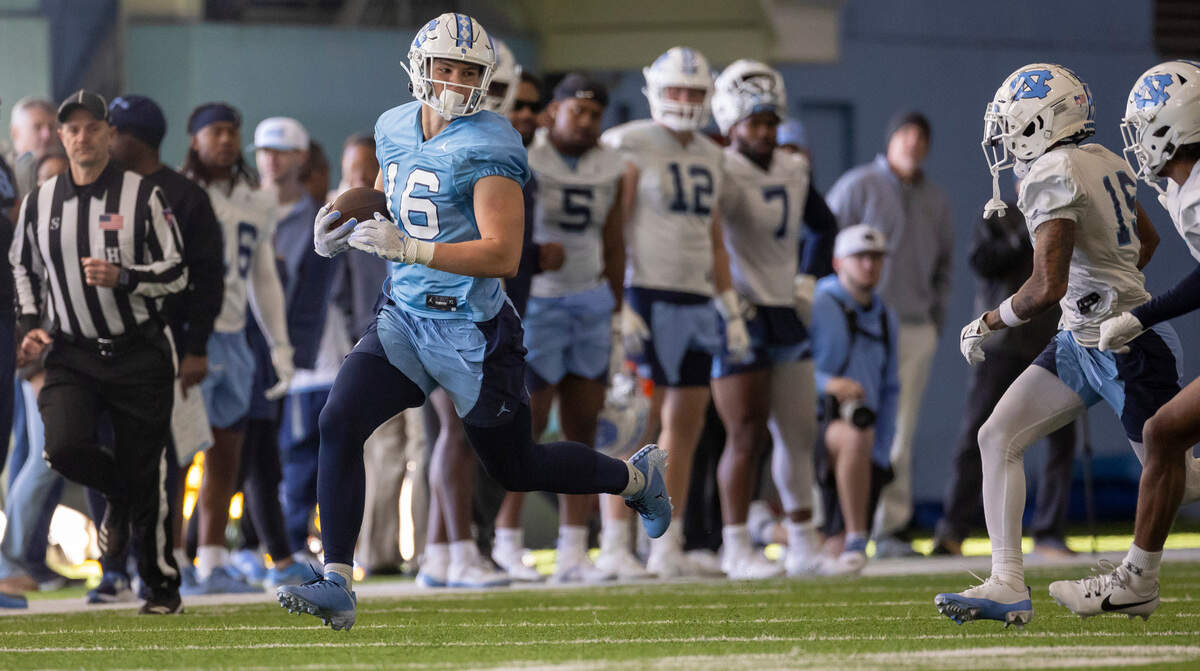 North Carolina tight end Ryan Ward (16) looks for running room after a pass reception during the opening day of spring football practice on Tuesday, March 19, 2024 in Chapel Hill, N.C.