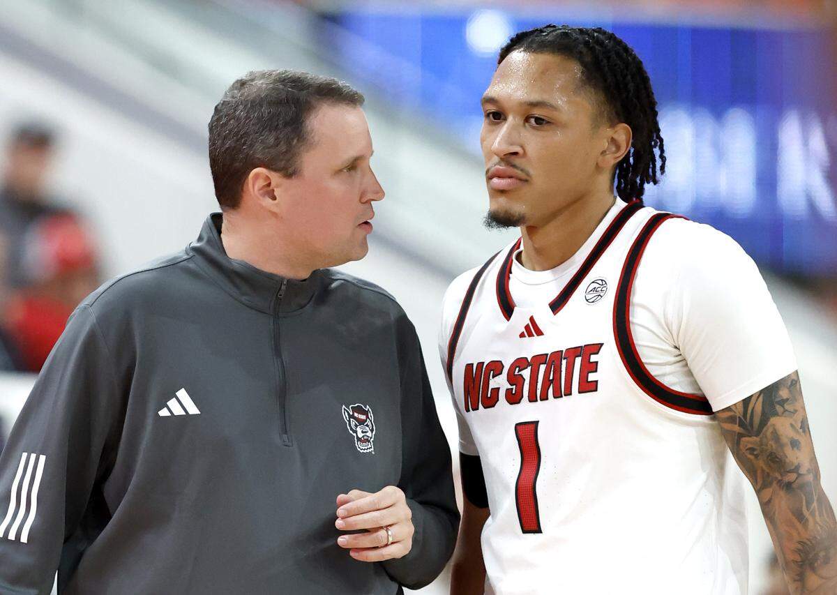 N.C. State's head coach Will Wade talks to Darrion Williams (1) during the first half of N.C. State’s game against UNC Asheville at the Lenovo Center in Raleigh, N.C., Saturday, Dec. 6, 2025.