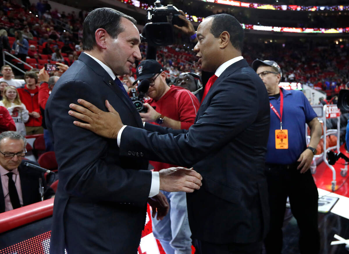 Duke head coach Mike Krzyzewski talks with N.C. State head coach Kevin Keatts before Duke’s game with N.C. State at PNC Arena in Raleigh, N.C., Wednesday, Feb. 19, 2020.