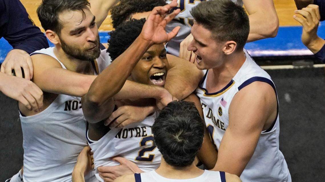 Notre Dame guard Trey Wertz (2) who sank the game winning shot is swarmed by teammates after their 80-77 win over Wake Forest in the first round of the Atlantic Coast Conference tournament in Greensboro, N.C., Tuesday, March 9, 2021. (AP Photo/Gerry Broome)