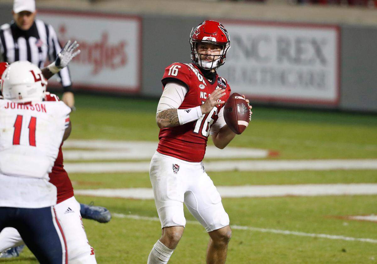 N.C. State quarterback Bailey Hockman (16) looks for receivers downfield during the second half of N.C. State’s 15-14 victory over Liberty at Carter-Finley Stadium in Raleigh, N.C., Saturday, Nov. 21, 2020.