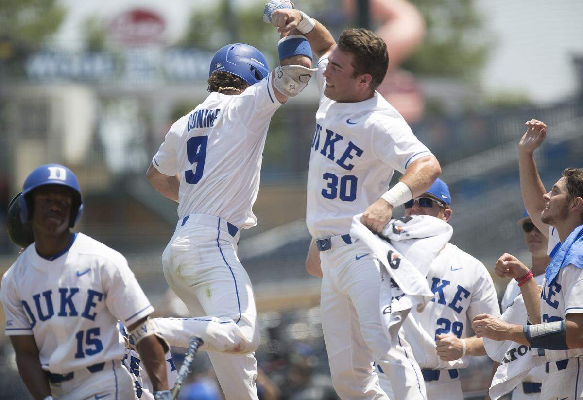 Duke’s Griffin Conine (9) celebrates with teammate Jimmy Herron (30) after connecting for a home run in the second inning, to give Duke a 1-0 lead over North Carolina on Sunday, May 13, 2018 at Durham Bulls Athletic Park in Durham, N.C.