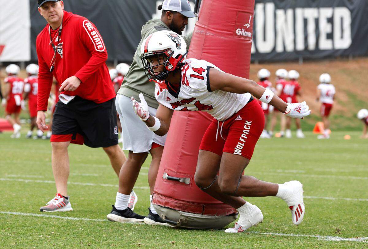 N.C. State cornerback Rente Hinton (14) runs drills during the Wolfpack’s first spring practice in Raleigh, N.C., Wednesday, March 1, 2023.