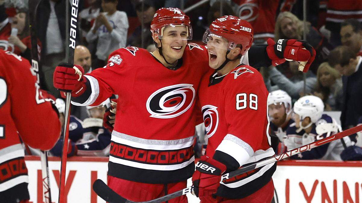 Carolina’s Martin Necas (88) celebrates with Brady Skjei (76) after Skjei scored during the second period of the Carolina Hurricanes game against the Columbus Blue Jackets at PNC Arena in Raleigh, N.C., Wednesday, Oct. 12, 2022.