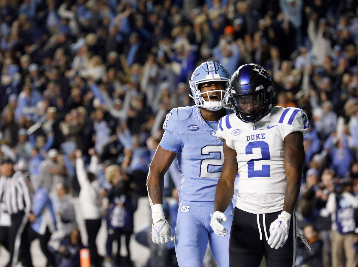North Carolina’s Don Chapman celebrates in front of Duke’s Sahmir Hagans after the Blue Devils failed to complete a two-point conversion, losing 47-45 in double overtime on Saturday, Nov. 11, 2023, at Kenan Stadium in Chapel Hill, N.C.