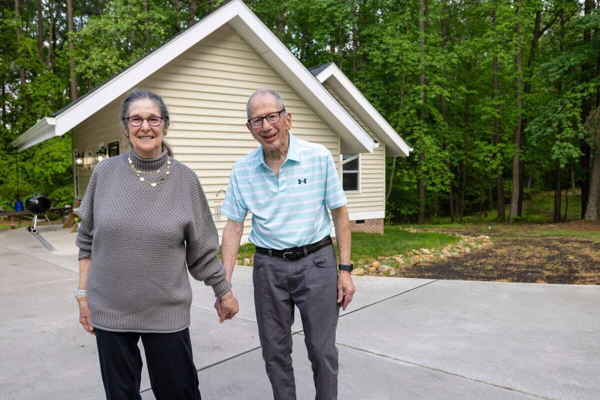 Abby and Bob Millhuaser in front of their 940 sq. ft. accessory dwelling unit, built just feet from Abby’s daughter’s home on Alloway Court in Raleigh, N.C.