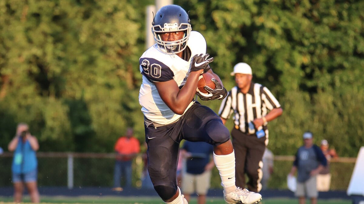 Heritage running back Trey Holloway (20) turns upfield after catching a screen pass against Millbrook on Friday, August 31, 2018.