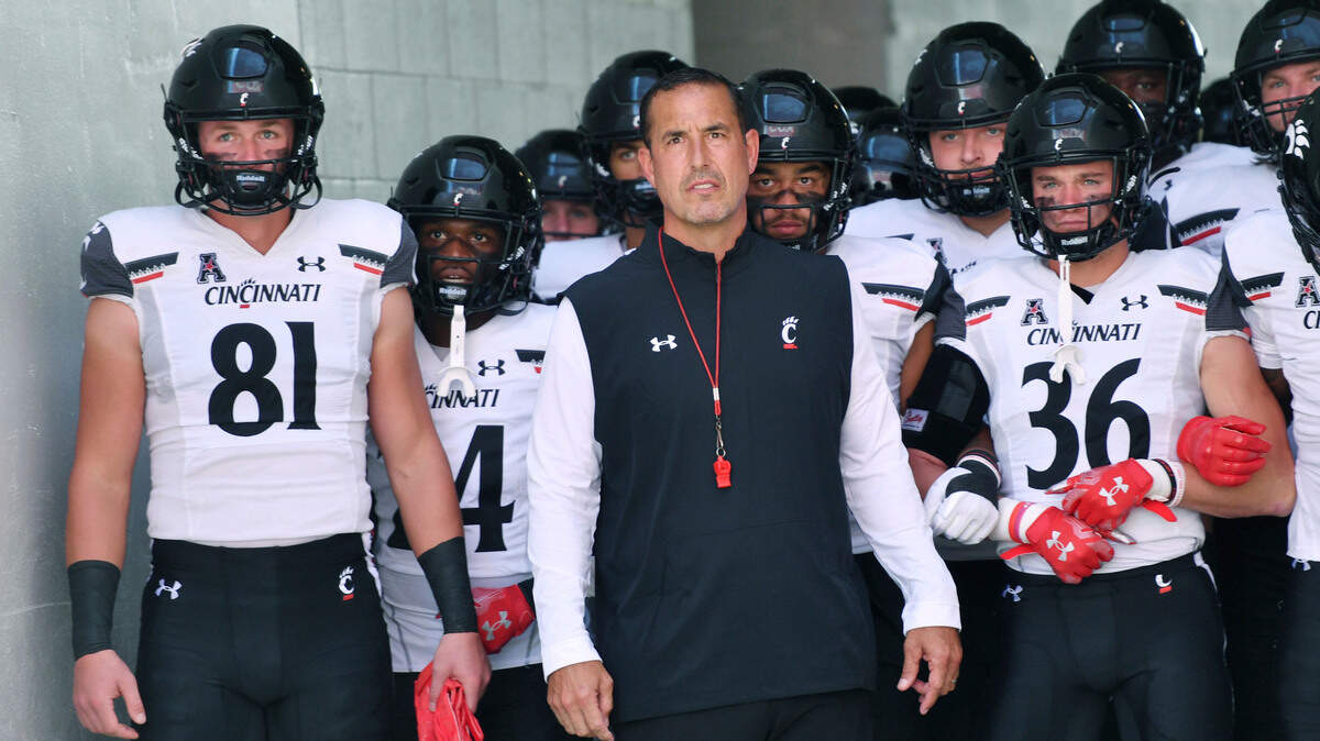 Cincinnati coach Luke Fickell gets ready to lead his team onto the field to play against Arkansas on Saturday, Sept. 3, 2022, in Fayetteville, Ark.