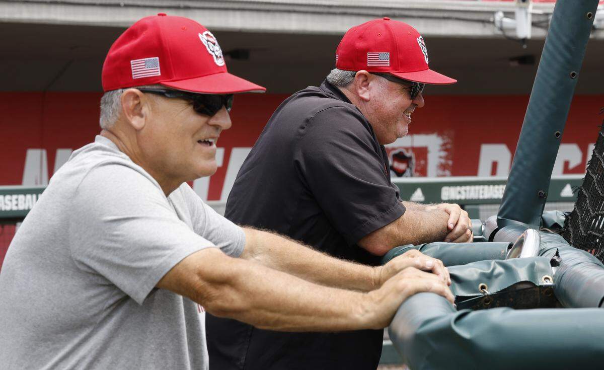 N.C. State associate head baseball coach Chris Hart, right, laughs with head coach Elliott Avent during batting practice during the WolfpackÕs practice at Doak Field Tuesday, May 26, 2026. 
