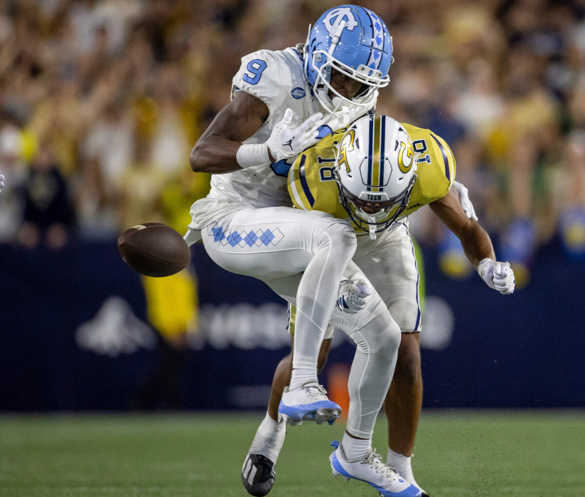 Georgia Tech’s Ahmari Harvey (18) collides with North Carolina’s Devontez Walker (9), forcing a fumble, after a 36-yard pass completion from quarterback Drake Maye with 2:54 to play in the game, securing a 46-42 victory for the Yellow Jackets on Saturday, October 28, 2023 at Bobby Dodd Stadium in Atlanta, Georgia.