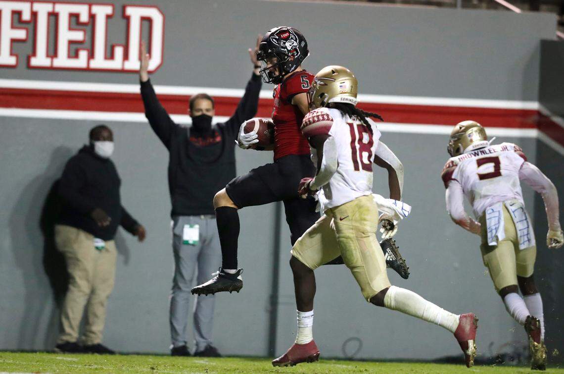 N.C. State wide receiver Thayer Thomas (5) heads into the end zone in front of Florida State defensive back Travis Jay (18) on 24-yard touchdown reception during the second half of N.C. State’s 38-22 victory over Florida State at Carter-Finley Stadium in Raleigh, N.C., Saturday, Nov. 14, 2020.