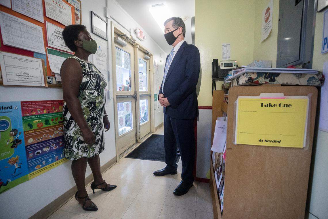 Gov. Roy Cooper visits with Anna Mercer-McLean, director of the Community School for People Under Six in Carrboro, N.C., on Thursday, Oct. 7, 2021.