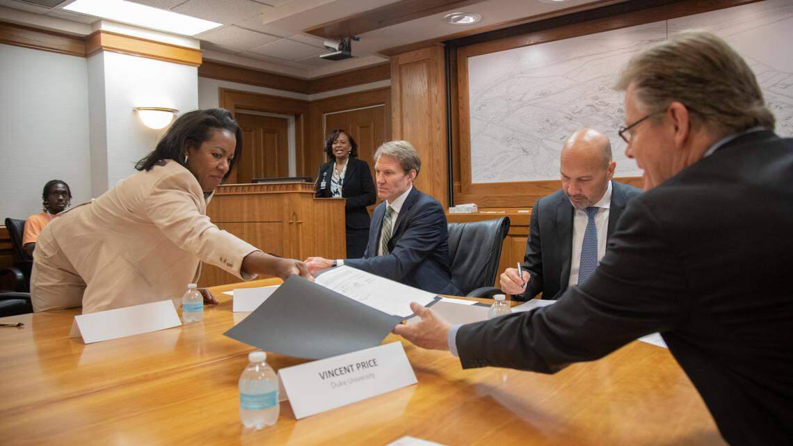 Stelfanie Williams, Vice President of Duke’s Office of Community Affairs, left, JB Buxton, President of Durham Technical Community College, Craig Albanese, CEO, Duke University Health System, and Vincent Price, President of Duke University, sign a collaboration between Duke University Health System, Duke Office of Durham and Community Affairs and Durham Technical Community College. The three organizations are joining forces to address the national nursing labor shortage crisis impacting North Carolina.