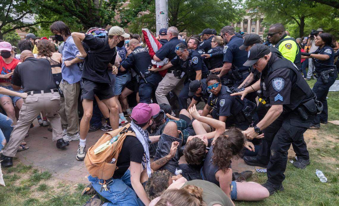 Pro-Palestinian demonstrators clash with police after replacing an American flag with a Palestinian flag Tuesday, April 30, 2024 at UNC-Chapel Hill. Police removed a “Gaza solidarity encampment” earlier Tuesday morning.