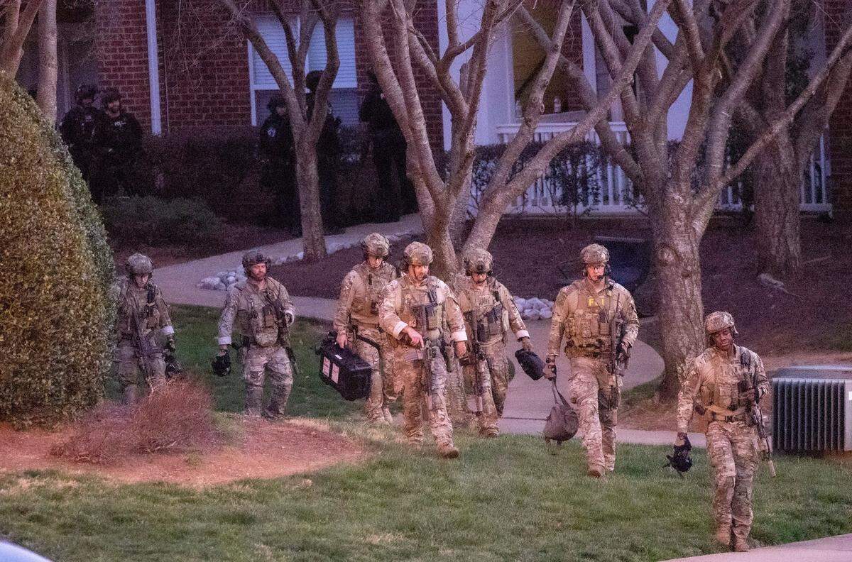 FBI agents and police work the scene of a standoff at Tryon Villages apartments Wednesday, Feb. 22, 2023.