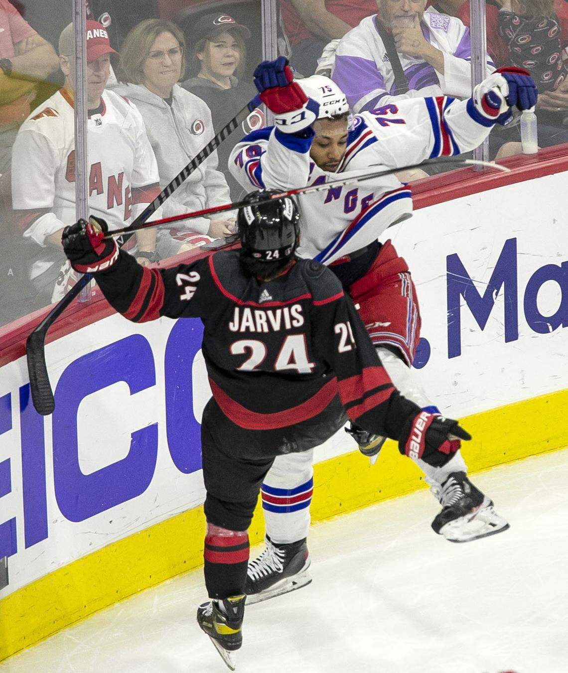 New York Rangers’ K’Andre Miller (79) checks Carolina Hurricanes’ Seth Jarvis (24) in the second period on Wednesday, May 18, 2022 during game one of the Stanley Cup second round at PNC Arena in Raleigh, N.C.