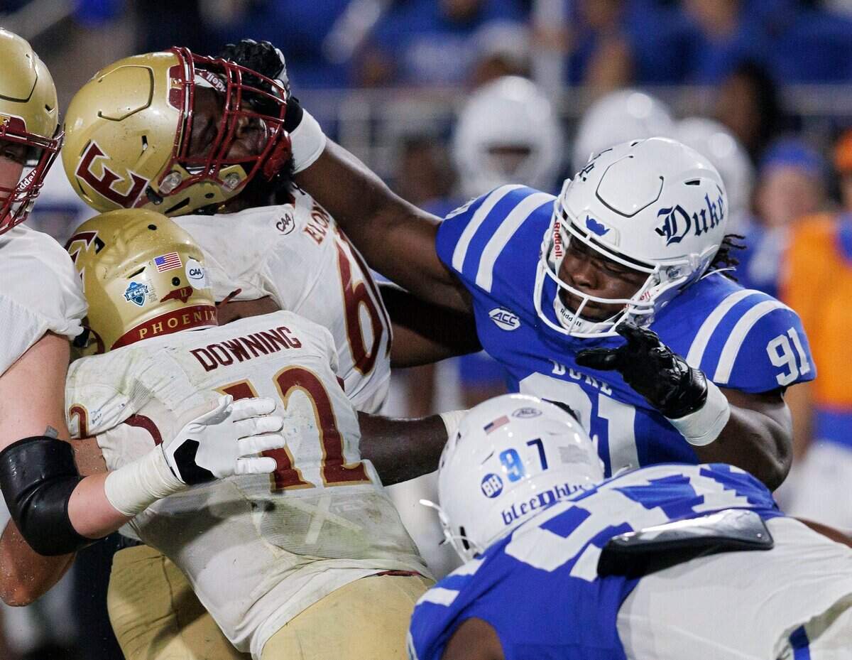 Duke’s Kendy Charles (91) fights through Elon’s Jabril Williams (61) while trying to get to Elon quarterback Matthew Downing during the second half of the Blue Devils’ 26-3 win on Friday, Aug. 30, 2024, at Wallace Wade Stadium in Durham, N.C.