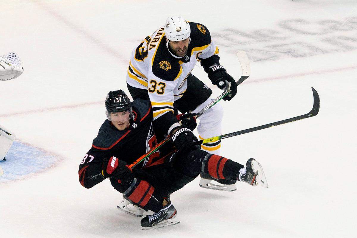 Carolina Hurricanes’ Andrei Svechnikov (37) is taken down by Boston Bruins’ Zdeno Chara (33) during third period NHL Eastern Conference Stanley Cup playoff game in Toronto on Saturday, Aug. 15, 2020.