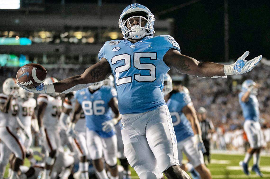 Javonte Williams (25) scores on a two-yard carry for a touchdown to give the Tar Heels a 17-3 lead over Miami in the first quarter on Saturday, September 7, 2019 at Kenan Stadium in Chapel Hill, N.C.