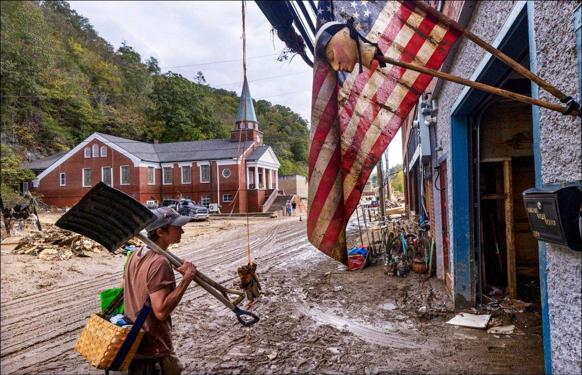 Jen Dombrowski arrives in downtown Marshall to help a friend clean up her business on Tuesday, Oct. 1, 2024 after the French Broad River caused catastrophic flooding. The remnants of Hurricane Helene caused widespread flooding, downed trees, and power outages in western North Carolina.