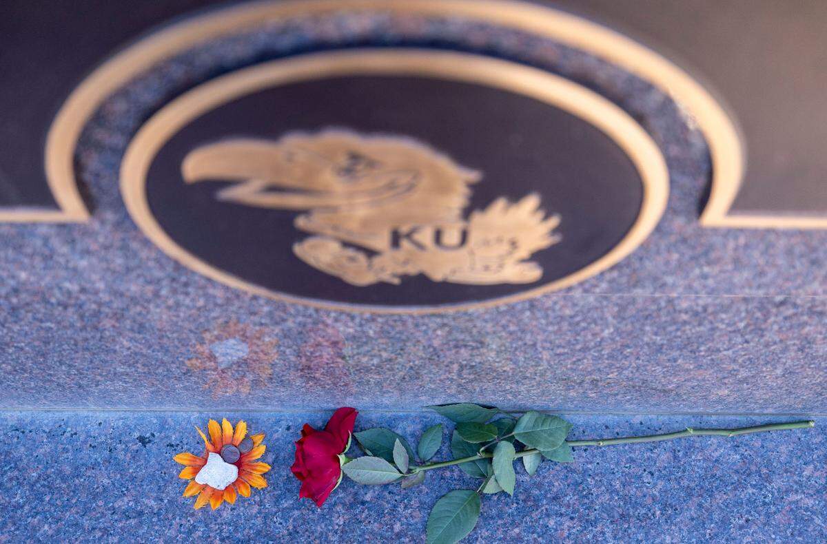 A memorial for James Naismith at the Memorial Park Cemetery is adorned with flowers, a rock and a coin, on Thursday, November 7, 2024 in Lawrence, Kansas.