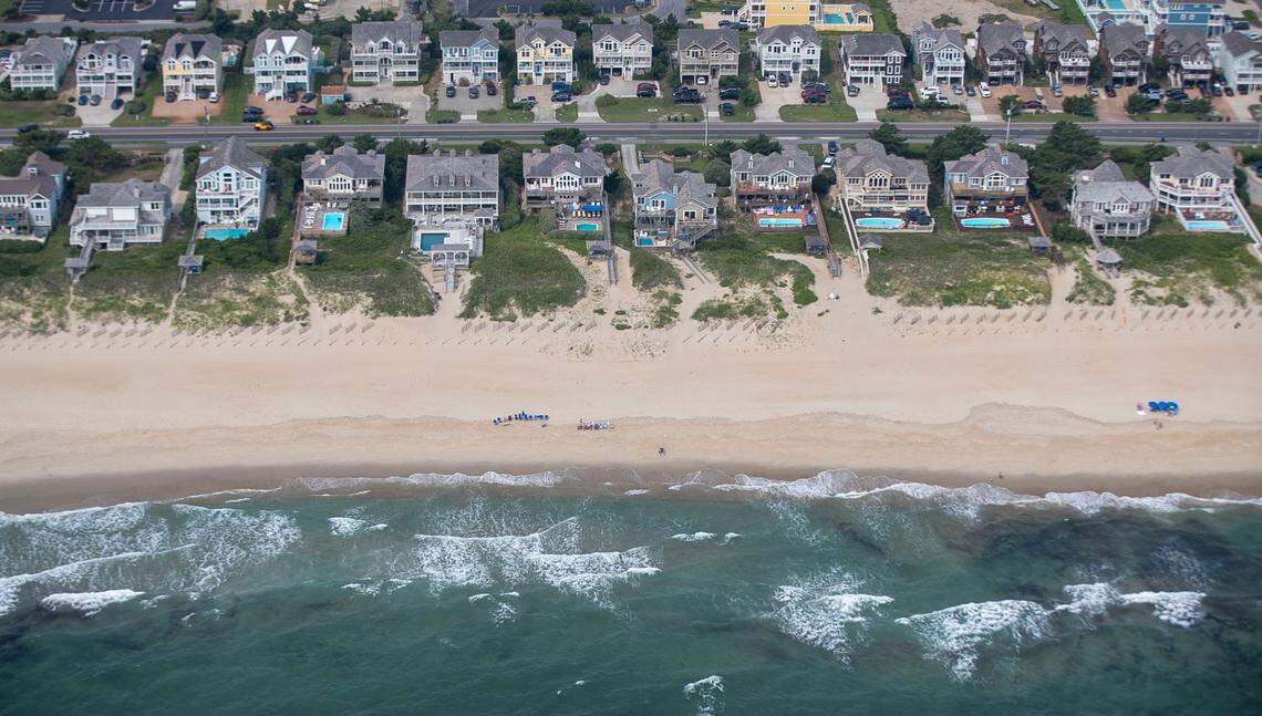 NC 12 runs through the densely developed beach front area of Nags Head, N.C. on Wednesday, July 21, 2021. Many of the large ocean front vacation homes feature their own swimming pools.