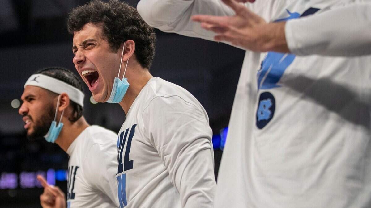 North Carolinas Ryan McAdoo (35), Creighton Lebo (25) and Duwe Farris (34) react after a dunk by teammate Armando Bacot (5) in the second half against Marquette on Thursday, March 17, 2022 during the NCAA Tournament at Dickies Arena in Ft. Worth, TX.