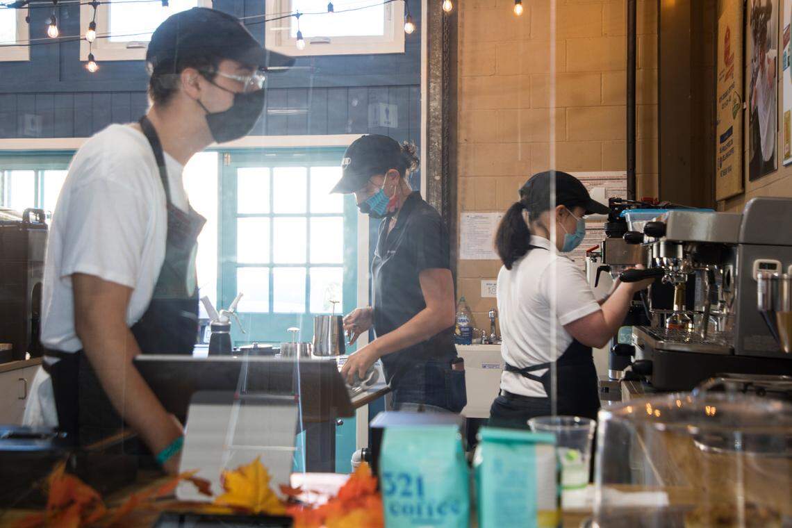 321 Coffee employee Logan Sniffen, left, CEO and co-founder Lindsay Wrege, middle, and employee Emma Wissink, right, work on drink orders at the State Farmers Market in Raleigh, N.C. on Oct. 15, 2021.