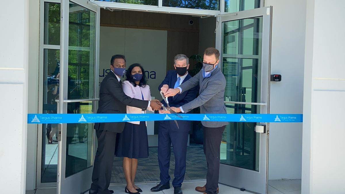 Governor Roy Cooper, second from right, cuts the ribbon at the Tergus Pharma facility on Thursday along with, from left, Dr. Vijendra Nalamothu, Chairman & CEO, Tergus Pharma, his wife Devi and Eddie Hjerpe, a member of the Tergus board of directors.