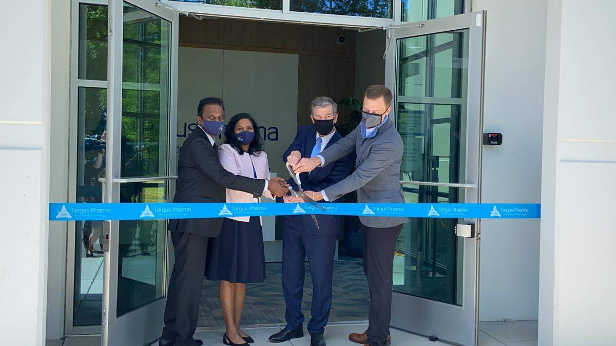 Governor Roy Cooper, second from right, cuts the ribbon at the Tergus Pharma facility on Thursday along with, from left, Dr. Vijendra Nalamothu, Chairman & CEO, Tergus Pharma, his wife Devi and Eddie Hjerpe, a member of the Tergus board of directors.