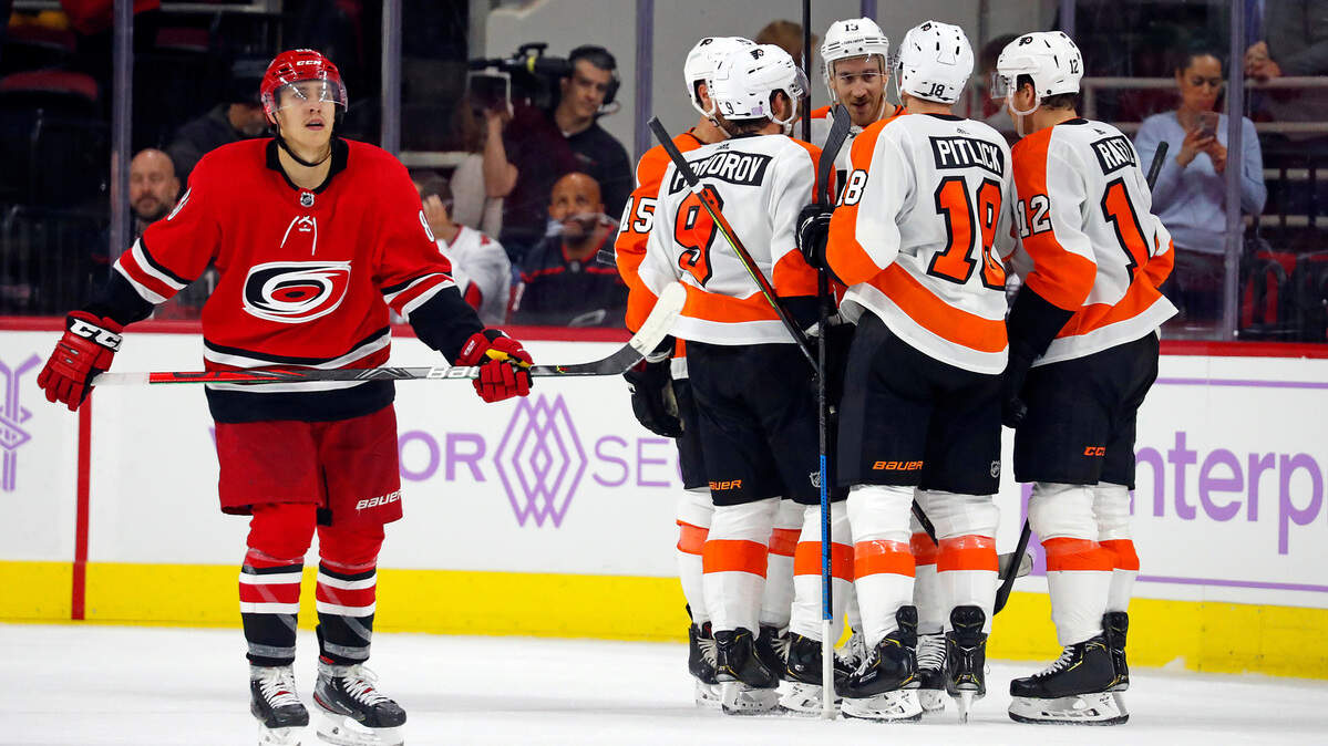 Philadelphia Flyers forward Kevin Hayes (13), center, celebrates his empty-net goal with teammates as Carolina Hurricanes forward Teuvo Teravainen (86), skates by during the third period of the Flyers’ 5-3 win on Thursday.