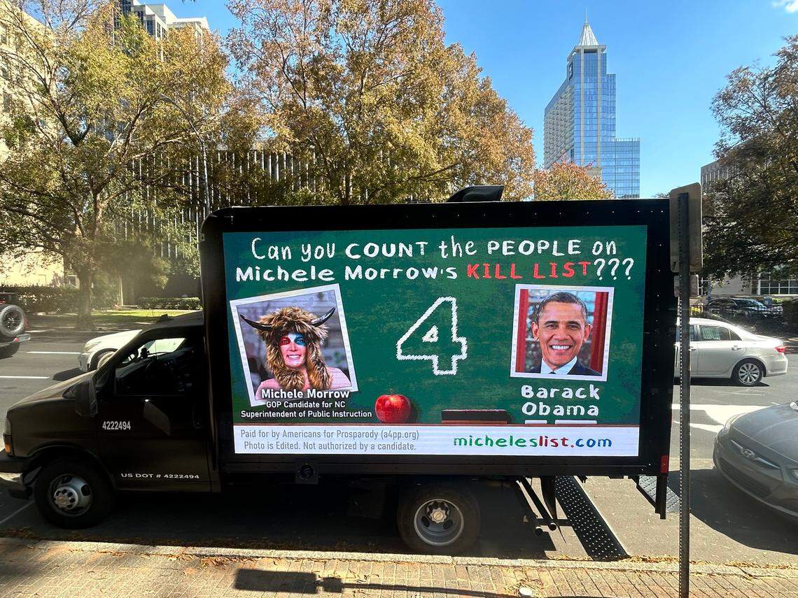 Mobile billboard targeting GOP candidate Michele Morrow’s past social media comments about killing people such as Barack Obama is parked at Nash Square in Raleigh. N.C., on Oct. 24, 2024. The ads are sponsored by a super PAC called Americans for Prosparody.