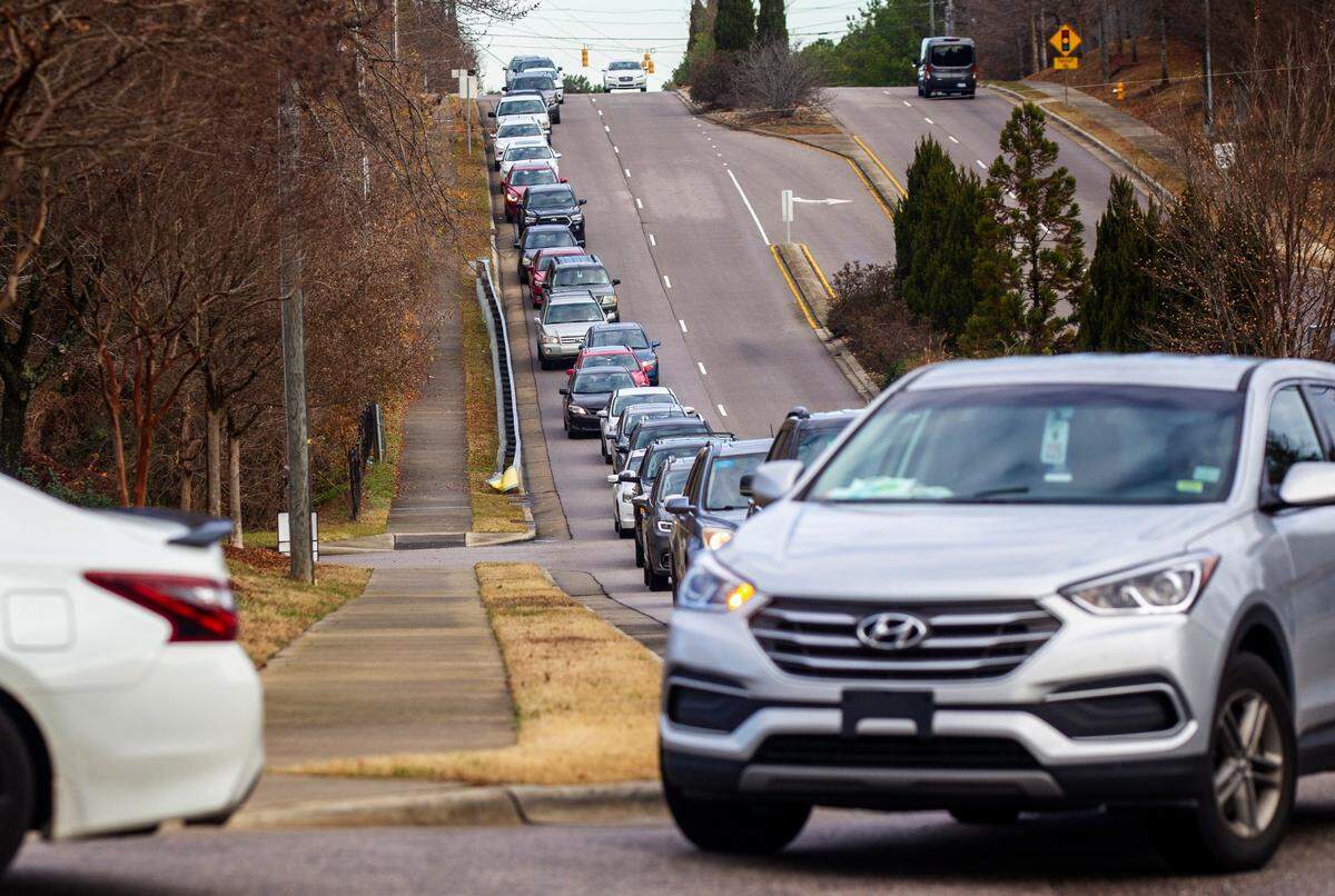 Vehicles line Kidd and Sunnybrook Roads at a COVID-19 testing site in Raleigh Wednesday morning Dec. 22, 2021. Waits of more than 40 minutes long were reported at the site.