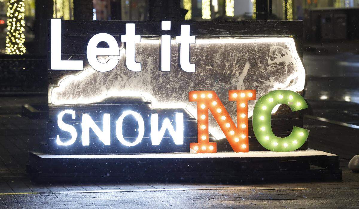 Snow falls in downtown Raleigh, N.C., Monday evening, Dec. 8. 2025.