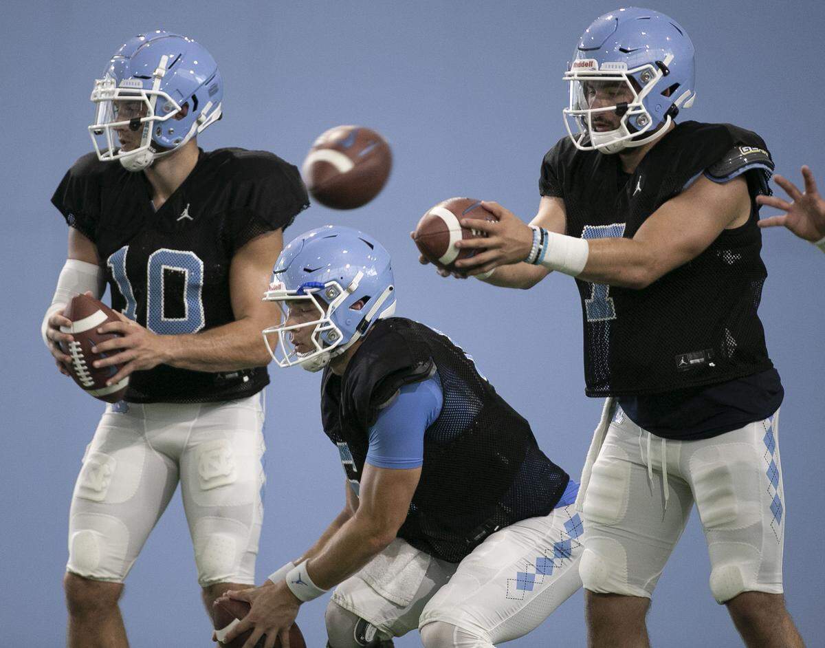 North Carolina quarterbacks Jace Ruder (10), Cade Fortin (6) and Sam Howell (7) takes snaps during the Tar Heels practice on Tuesday, August 6, 2019 at the Football Practice Facility in Chapel Hill, N.C.