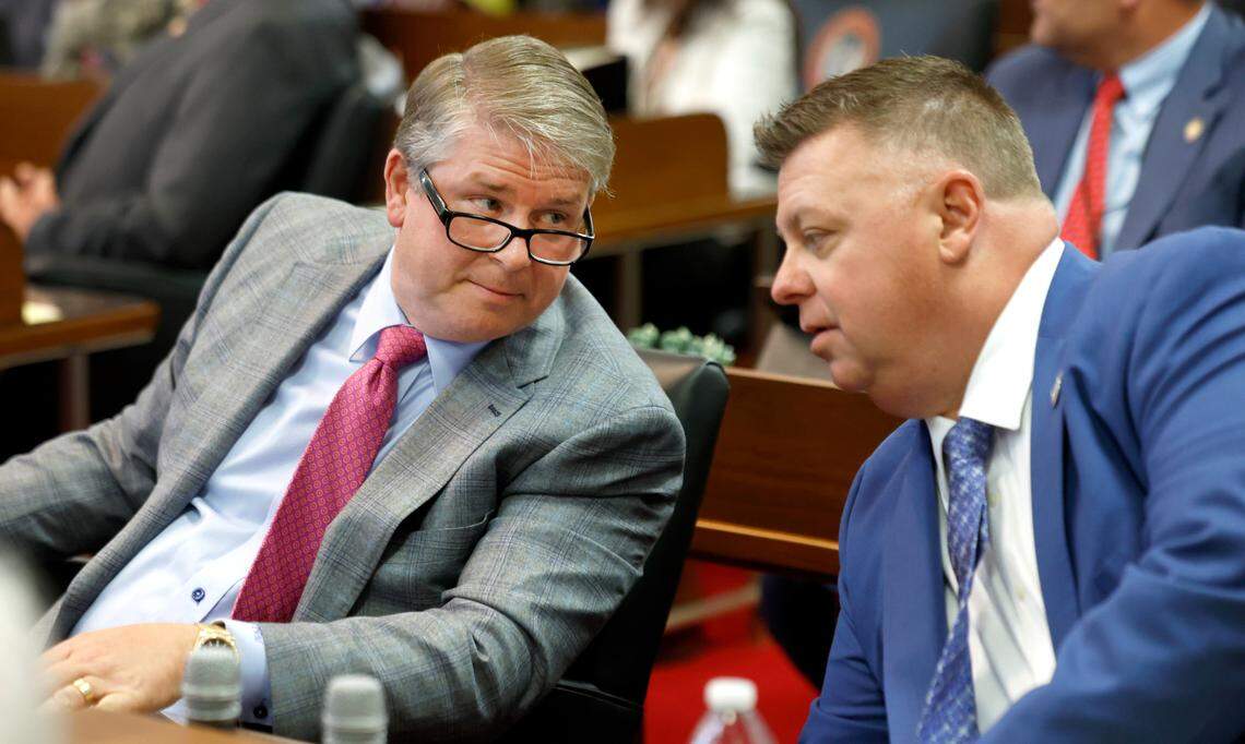 Rep. Grey Mills, left, talks with Rep. Jason Saine before the start of session in the N.C. House Tuesday, June 11, 2024.