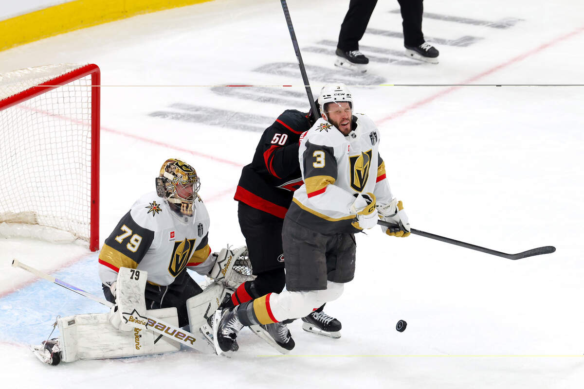 Brayden McNabb (3) of the Vegas Golden Knights falls to the ice after being hit in the face by the puck during the first period against the Carolina Hurricanes in Game 2 of the 2026 Stanley Cup Final at Lenovo Center on June 4, 2026 in Raleigh, North Carolina.