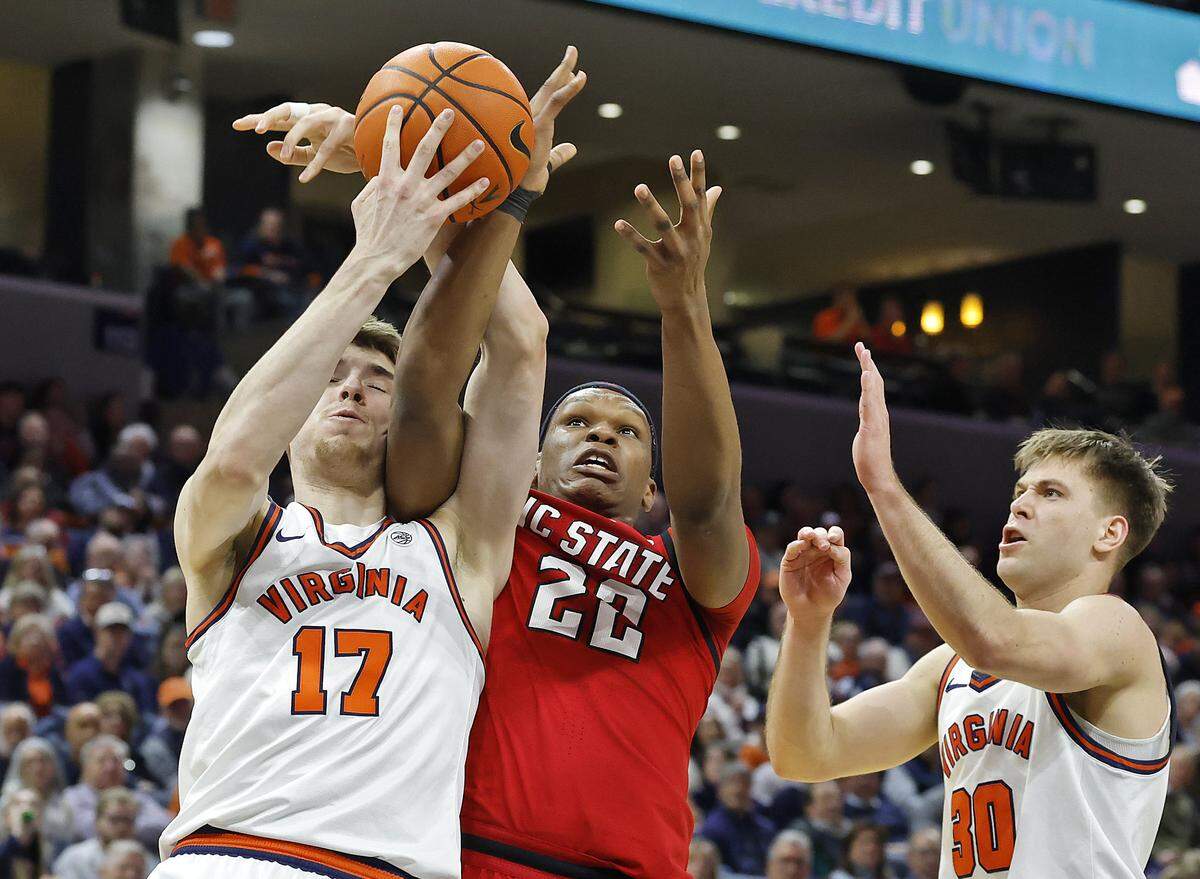 Virginia's Johann Grünloh battles N.C. State's Ven-Allen Lubin for a rebound during the first half of the Wolfpack’s game on Thursday, Feb. 24, 2026, at John Paul Jones Arena in Charlottesville, Va.