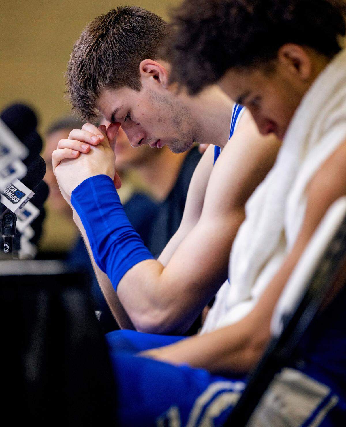 Duke’s Kyle Filipowski (30) hangs his head during post game interviews with coach Jon Scheyer, teammates Jeremy Roach (3) and Tyrese Proctor (5) following their 65-52 loss to Tennessee in the second round of the NCAA Tournament on Saturday, March 18, 2023 at the Amway Center in Orlando, Fla.