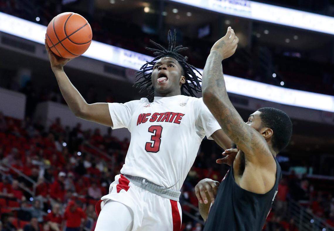 N.C. State’s Cam Hayes (3) drives past Louisville’s Malik Williams (5) during the second half of Louisville’s 73-68 victory over N.C. State at PNC Arena in Raleigh, N.C., Saturday Dec. 4, 2021.