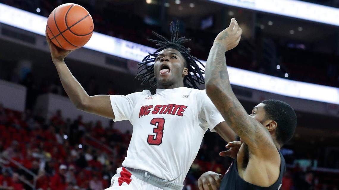 N.C. State’s Cam Hayes (3) drives past Louisville’s Malik Williams (5) during the second half of Louisville’s 73-68 victory over N.C. State at PNC Arena in Raleigh, N.C., Saturday Dec. 4, 2021.