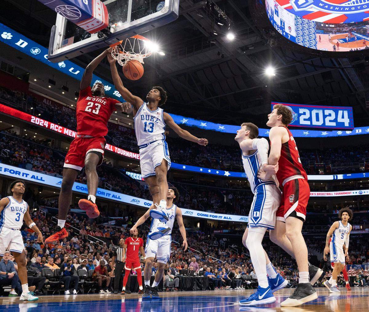 N.C. State’s Casey Morsell (14) and Mohamed Diarra (23) defend Duke’s Tyrese Proctor (5) in the second half during the quarterfinals of the ACC Men’s Basketball Tournament at Capitol One Arena on Wednesday, March 13, 2024 in Washington, D.C.