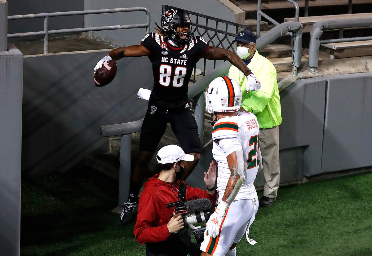 N.C. State wide receiver Devin Carter (88) celebrates after scoring on a 11-yard touchdown reception during the first half of N.C. State’s game against Miami at Carter-Finley Stadium in Raleigh, N.C., Friday, Nov. 6, 2020.