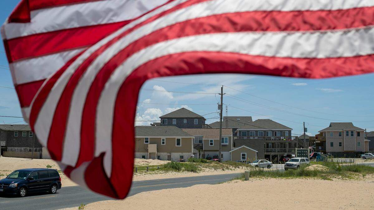 The American Flag is whipped by the wind along NC 12 at the Cape Hatteras Motel on Thursday, July 1, 2021 in Buxton, N.C.