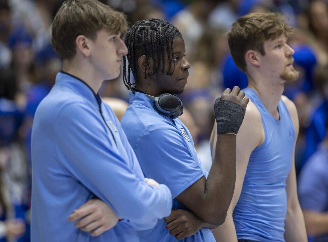 North Carolina forward Caleb Wilson (8), out with a broken thumb, is flanked by centers Ivan Matlekovic (40), and Henri Veesaar (13), as the Tar Heels warm up for their game against Duke on Saturday, March 7, 2026 at Cameron Indoor Stadium in Durham, N.C.