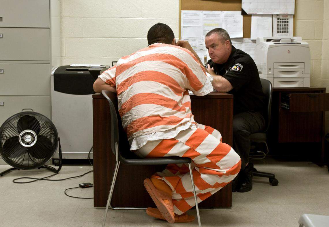 An inmate who is charged with a conspiracy of selling drug (cocaine) gets processed by Wake County detention officer John Evers Tuesday, Nov. 17, 2009. He is processed for 287g, the program that lets sheriffs identify and start deportation of illegal immigrants. This inmate is from Mexico.