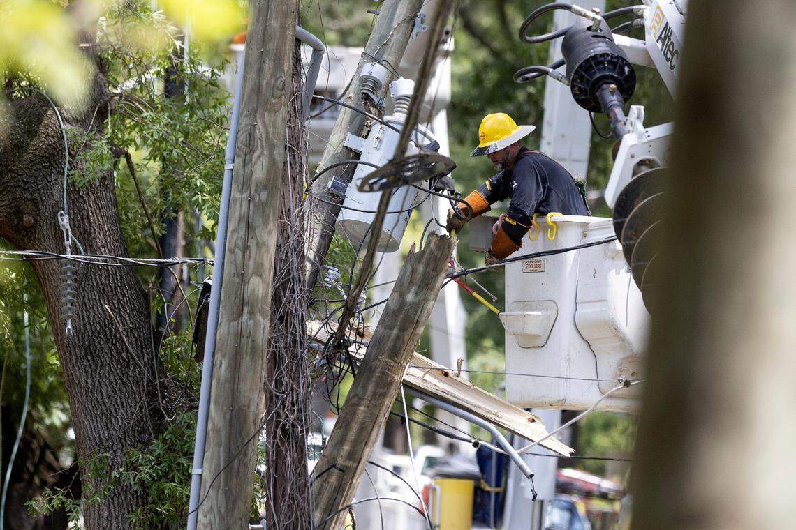Crews work to detangle power lines near the intersection of West Markham Avenue and Washington Street on Wednesday, Aug. 16, 2023, following Tuesday evening’s strong storms in Durham, N.C.