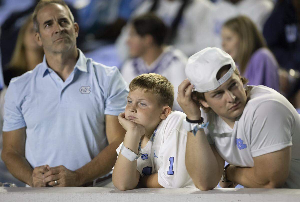 Michael Conley, and his sons Beckett Conley and Graham Conley watch the closing minutes of the third quarter as the Tar Heels trail Texas Christian 41-14 on Monday, September 1, 2025 at Kenan Stadium in Chapel Hill, N.C. 