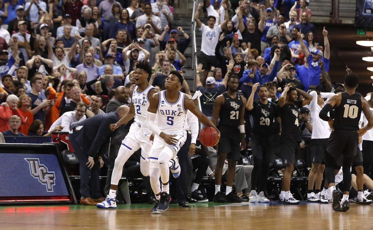 Duke’s RJ Barrett (5) and Cam Reddish (2) celebrate as time runs out during the second half of Duke’s 77-76 victory over UCF in the second round of the NCAA Men’s Basketball Championship in Columbia, S.C., Sunday, March 24, 2019.